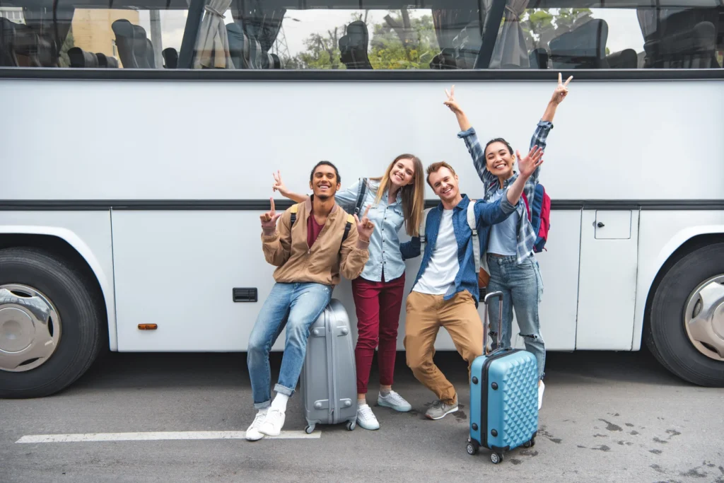 cheerful-multiethnic-tourists-with-travel-bags ahead of charter bus allentown pa