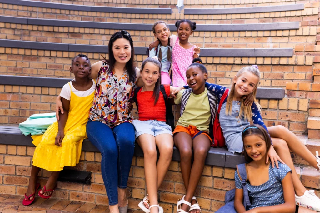 portrait-of-diverse-female-teacher-and-schoolgirls